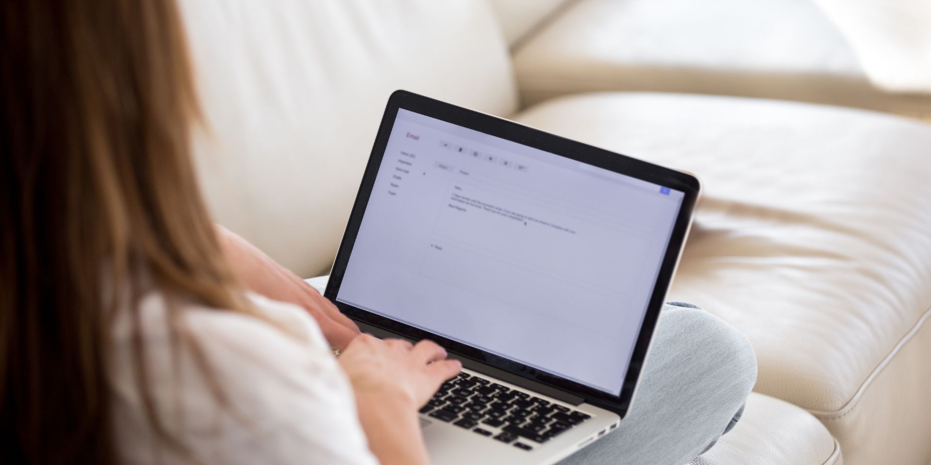 Woman writing on laptop