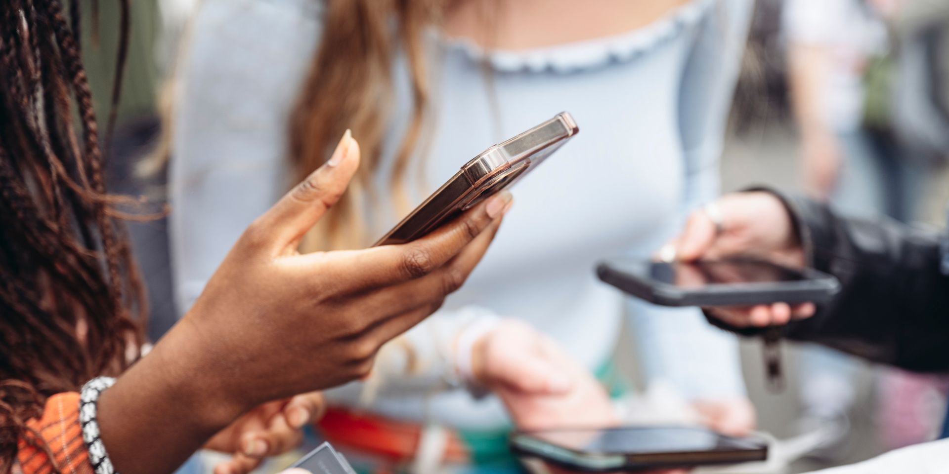 A group of ladies holding their phones.