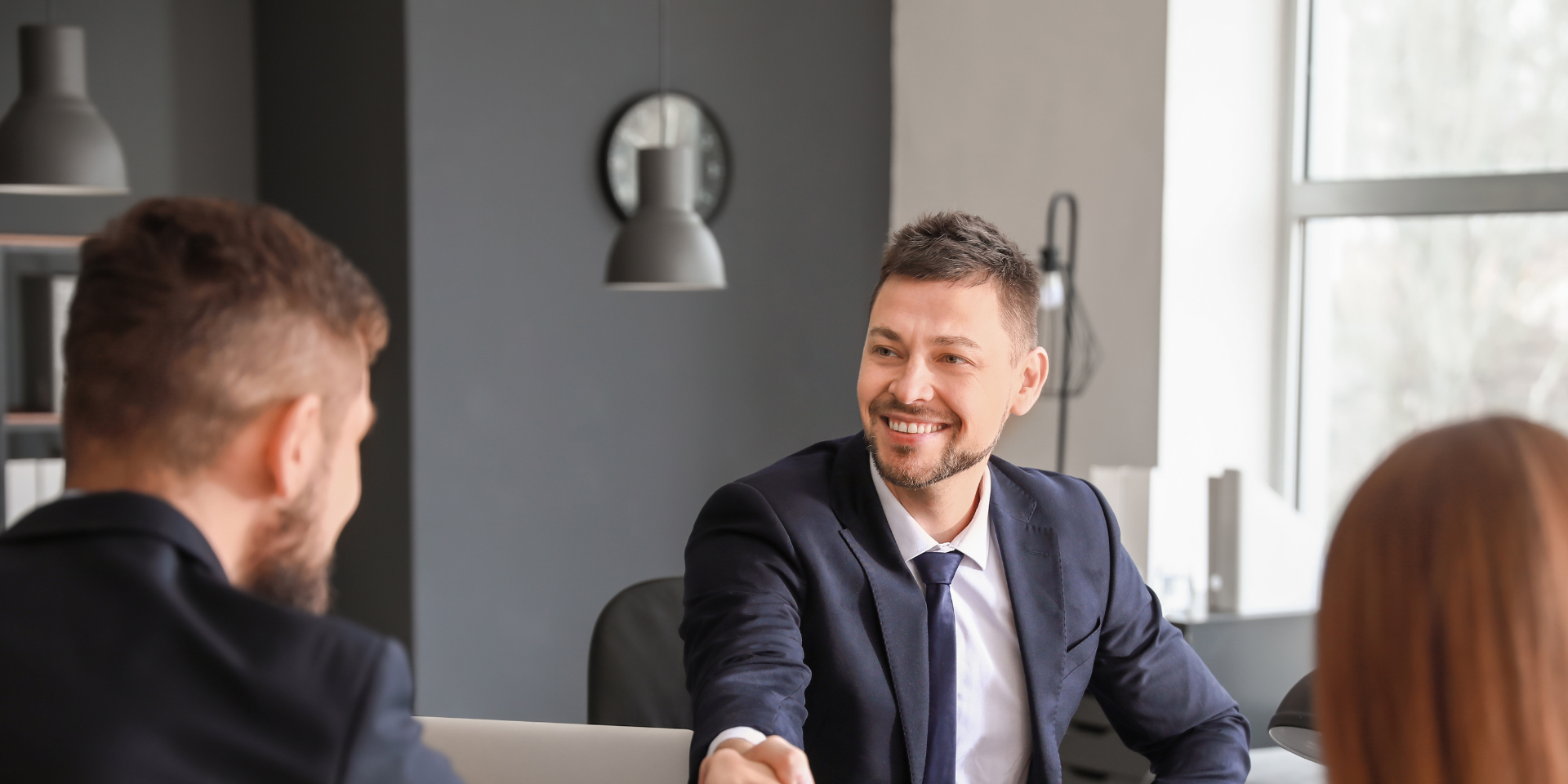 A meeting of clients sat around a table.