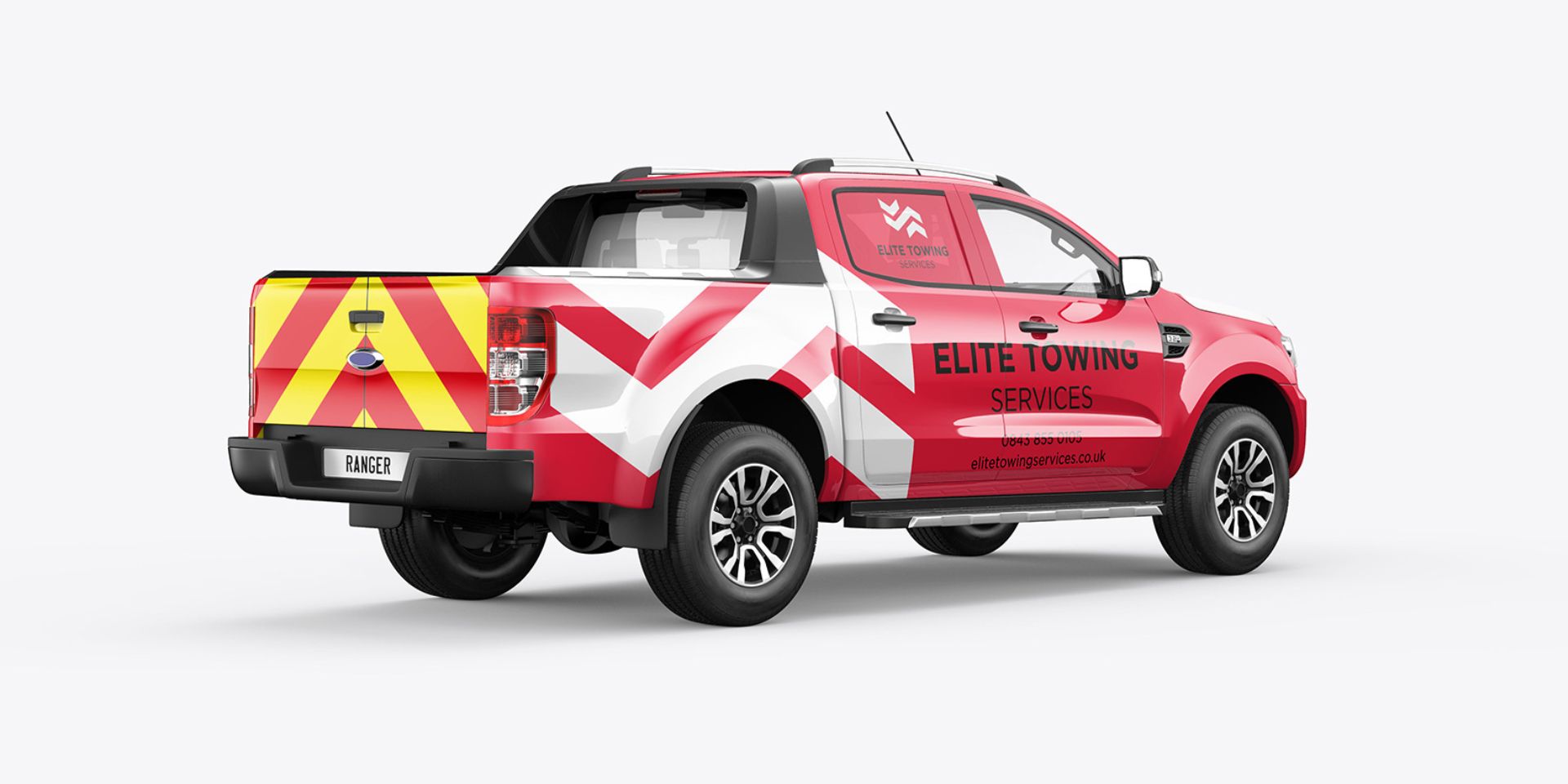 A red vehicle wrapped truck is shown with white chevron details.