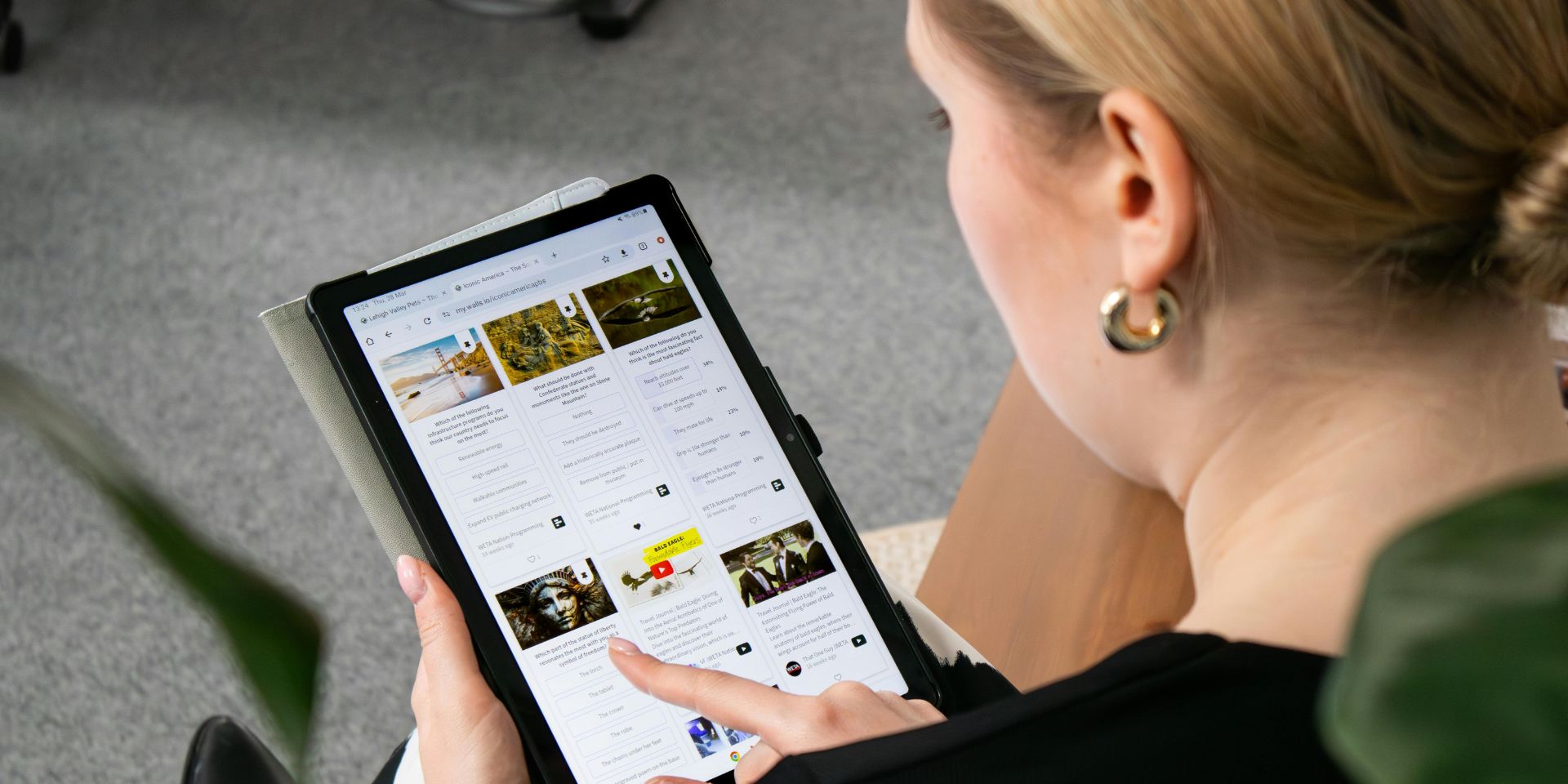 A woman looks at social media profiles on her tablet device.