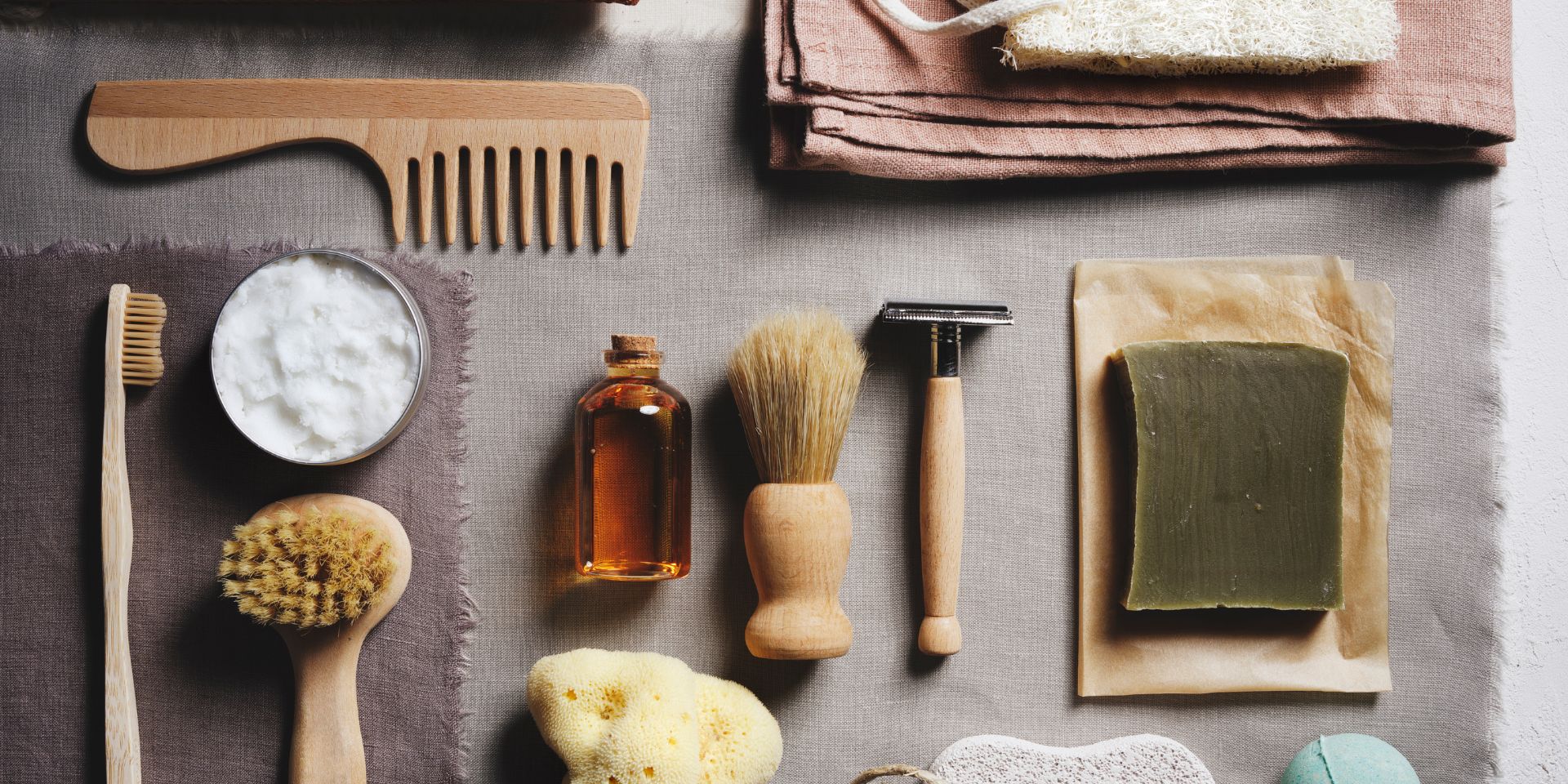A flat lay of men's skincare products and accessories such as a razor.