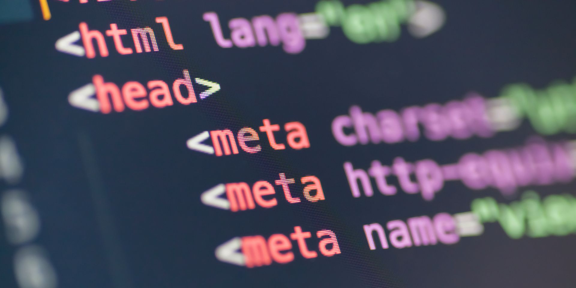 A computer screen shows red, purple and green code, against a black background.