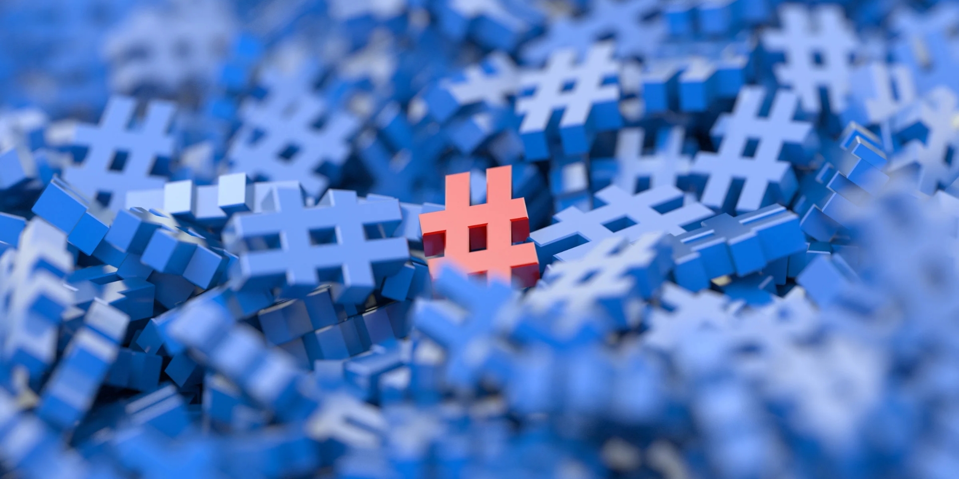 A pile of cobalt blue hashtag signs contrasts with a single coral red hashtag symbol.
