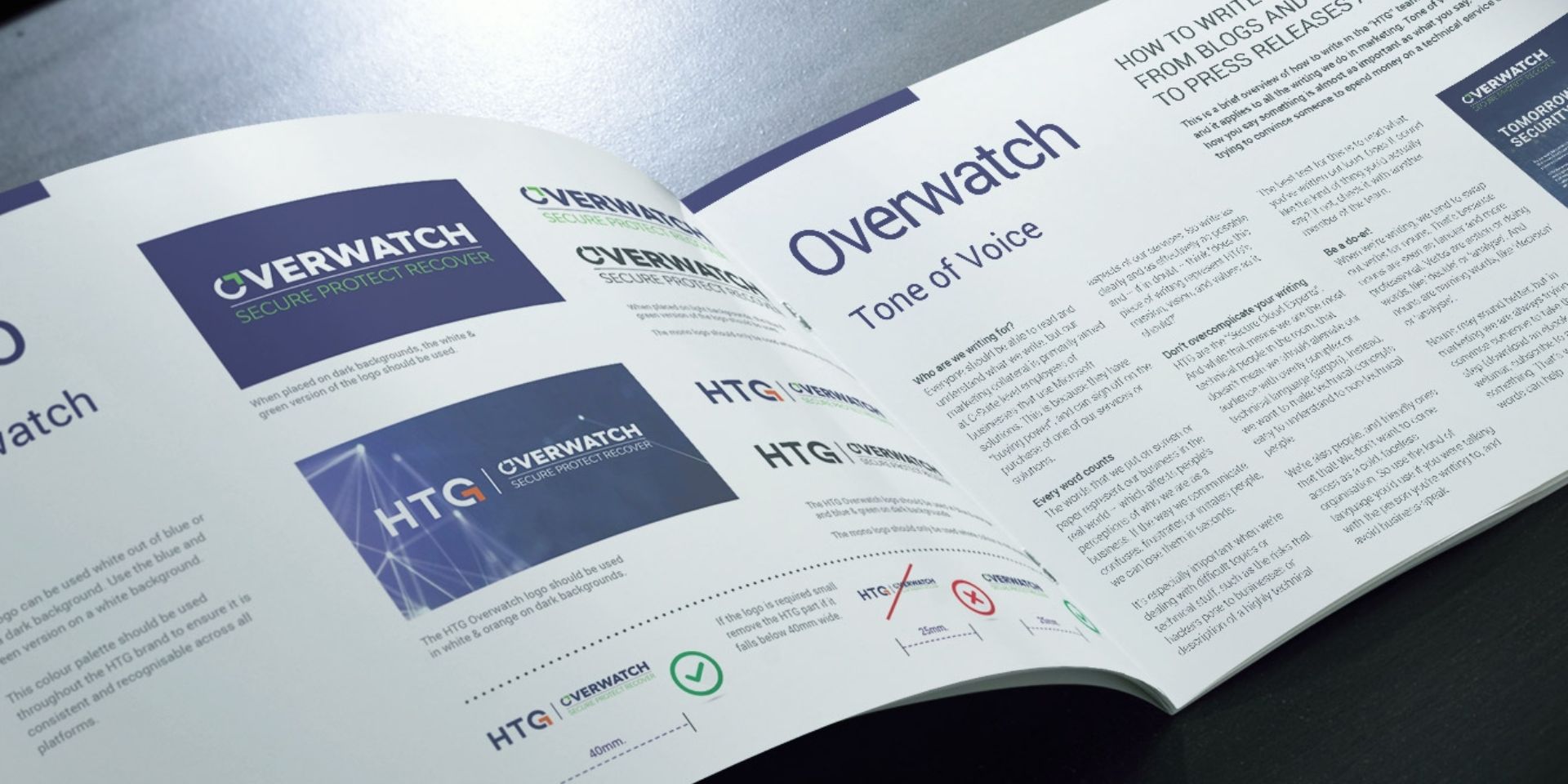 A brand guidelines document which is open against a grey desk.