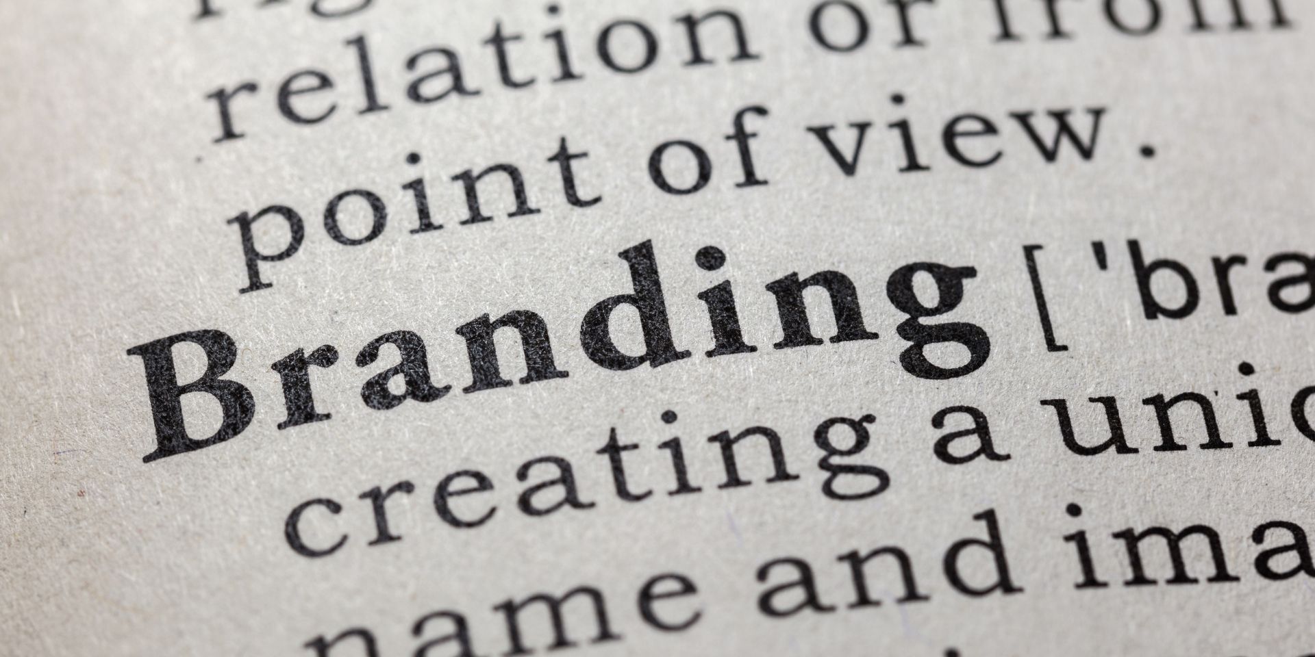 A close up image on the word "Branding" in a dictionary page with black and white text.